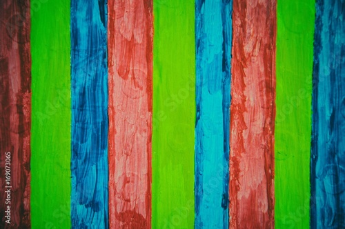 Lime green, blue and red stripes on wood panel background