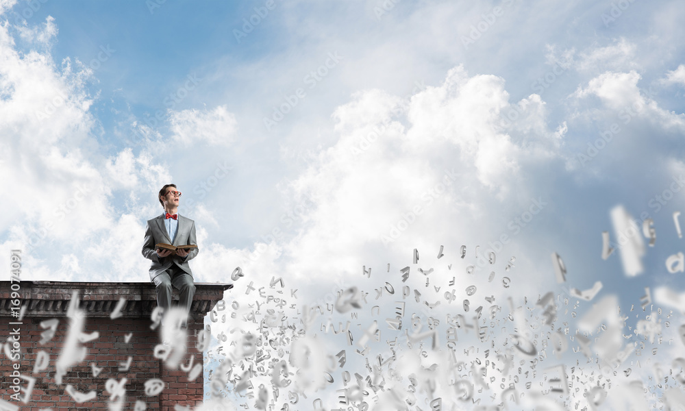 Young businessman or student studying the science and symbols fly around Young businessman or student studying the science and symbols fly around