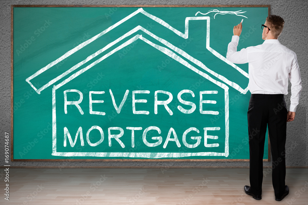 Businessman Drawing House With Reverse Mortgage Text Businessman Drawing House With Reverse Mortgage Text