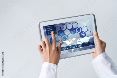 Close of female doctor hands working with tablet pc computer