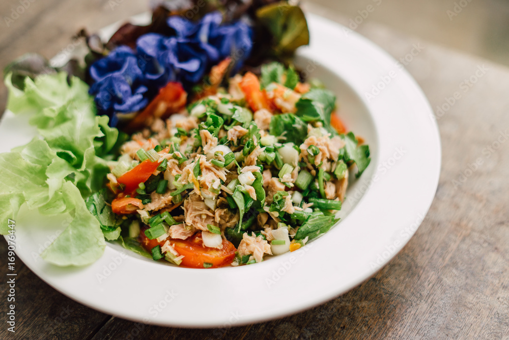 Tuna spicy salad with Thai herb on white plate. Tuna spicy salad with Thai herb on white plate.