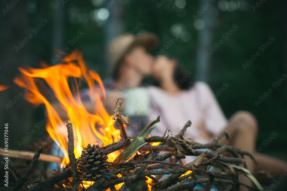 Camp fire in the night. Sensual couple. Having sex. Kissing couple. Just one kiss. Love story