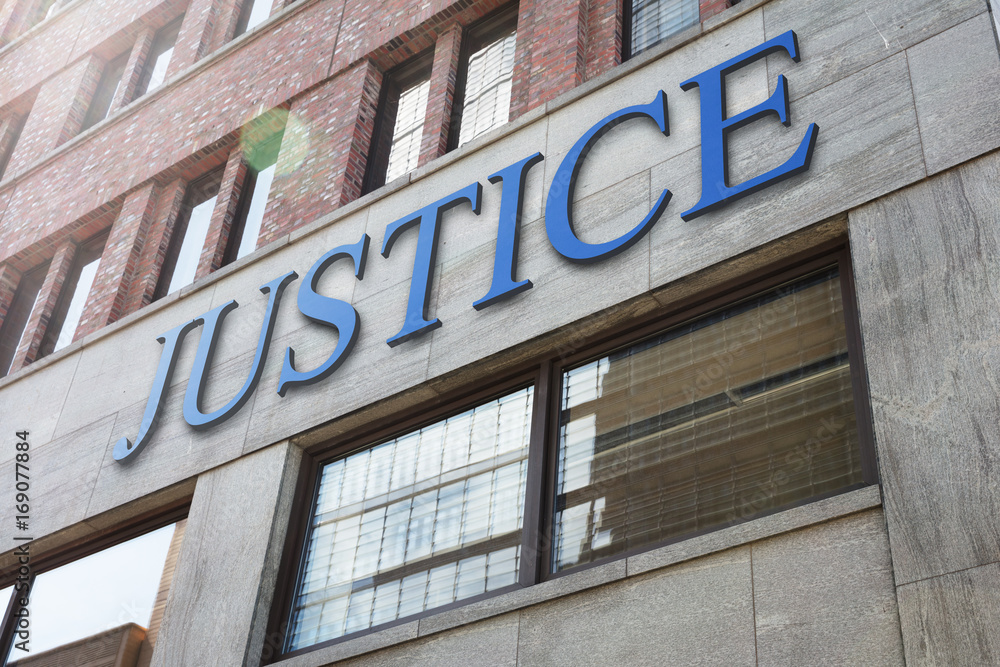 Justice sign on modern building in city Justice sign on modern building in city