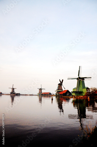 The windemill in the Kinderdijk town in Holland, with the landscape of village, river, meadow and farm