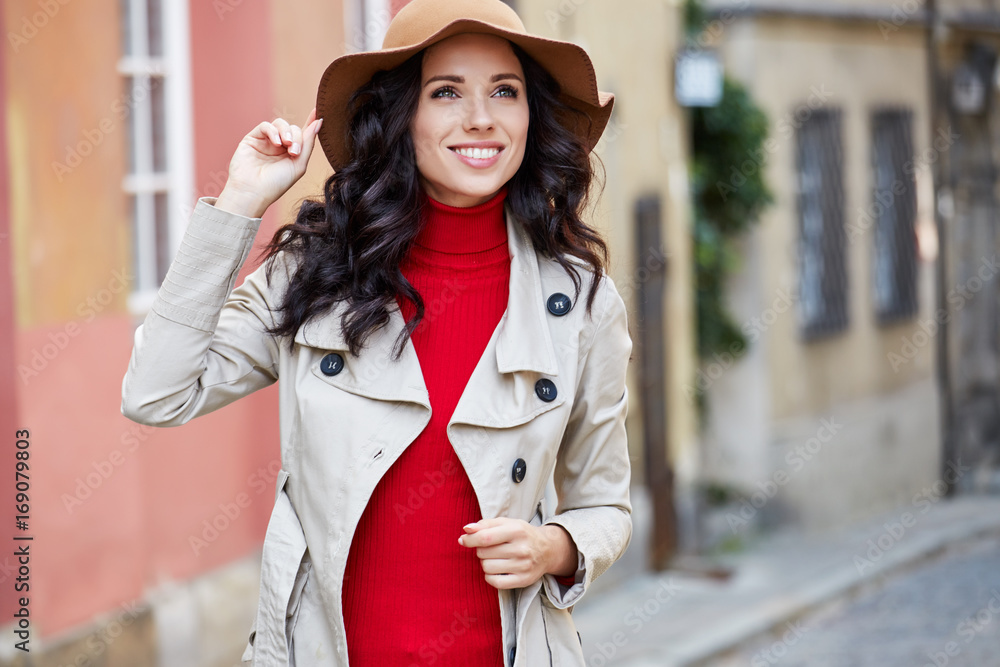 Fototapeta premium Beautiful woman in autumn style in town. Fashionable concept