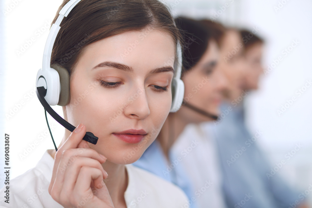 Call center operator.Young beautiful business woman in headset Call center operator.Young beautiful business woman in headset