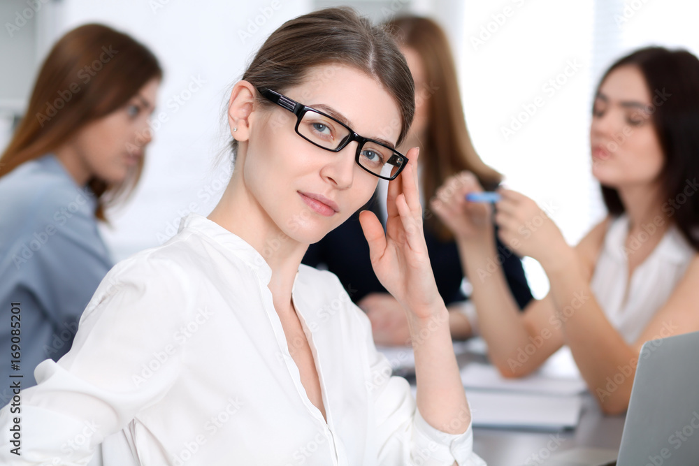 Beautiful business woman smiling at meeting or negotiation Beautiful business woman smiling at meeting or negotiation