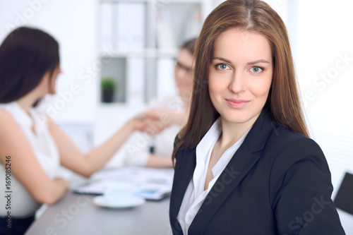Beautiful business woman smiling at meeting or negotiation