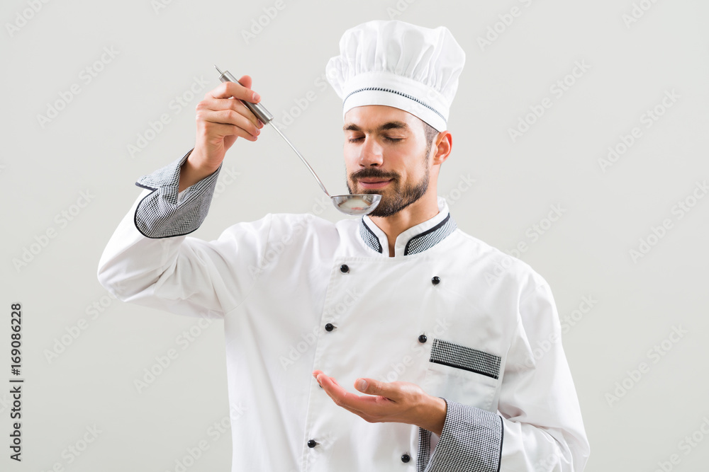 Chef enjoys smelling meal that he has made.