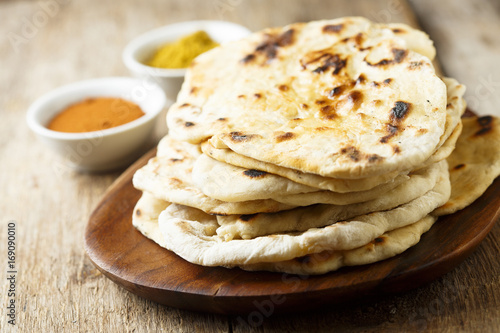 Bild auf Leinwand Indian naan bread on wooden desk