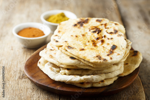 Tableau sur toile Indian naan bread on wooden desk