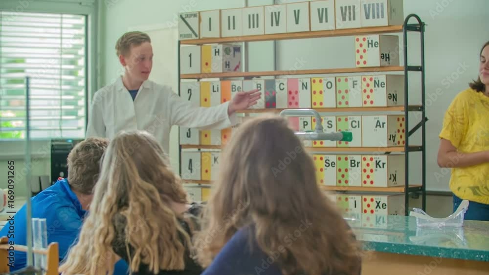 Students are learning about chemical elements together. They are having a chemistry class. Students are learning about chemical elements together. They are having a chemistry class.