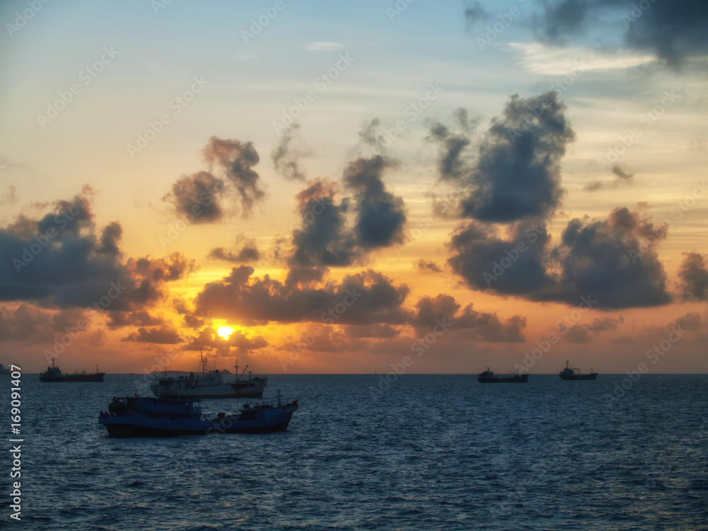 Several boats anchored at sunset