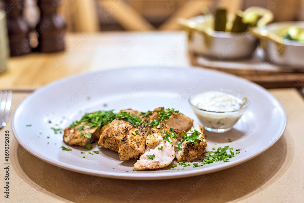 Turkey meat stake fillet with parsley on a white plate in a restaurant, delicious dish Turkey meat stake fillet with parsley on a white plate in a restaurant, delicious dish
