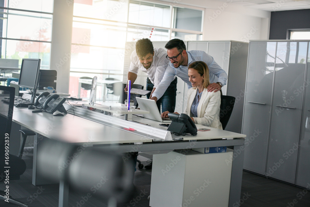 Three colleague in office using computer Business people in office.