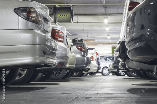 Crowded parking lot, car rear end in parking lot.
