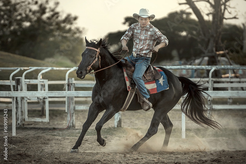 A cowboy riding a horse in his farm