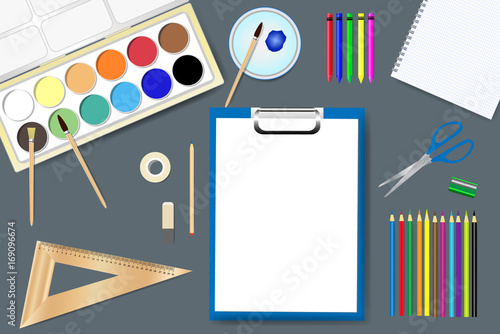Drawing supplies are lying around empty notepad ready for your text. 