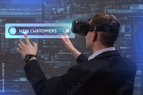 Business, Technology, Internet and network concept. Young businessman working on a virtual screen of the future and sees the inscription: New customers