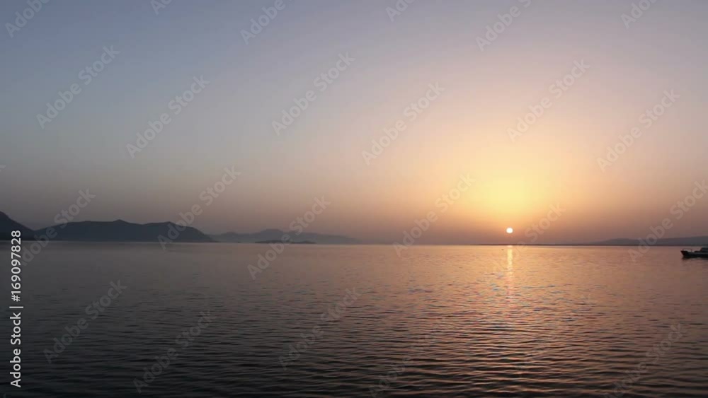 Ferry boat is in transport on early dawn, passing over sea at sunrise
View on morning horizon with a ferry boat that is crossing over calm sea.
Ferry boat is in transport on early dawn, passing over sea at sunrise
View on morning horizon with a ferry boat that is crossing over calm sea.