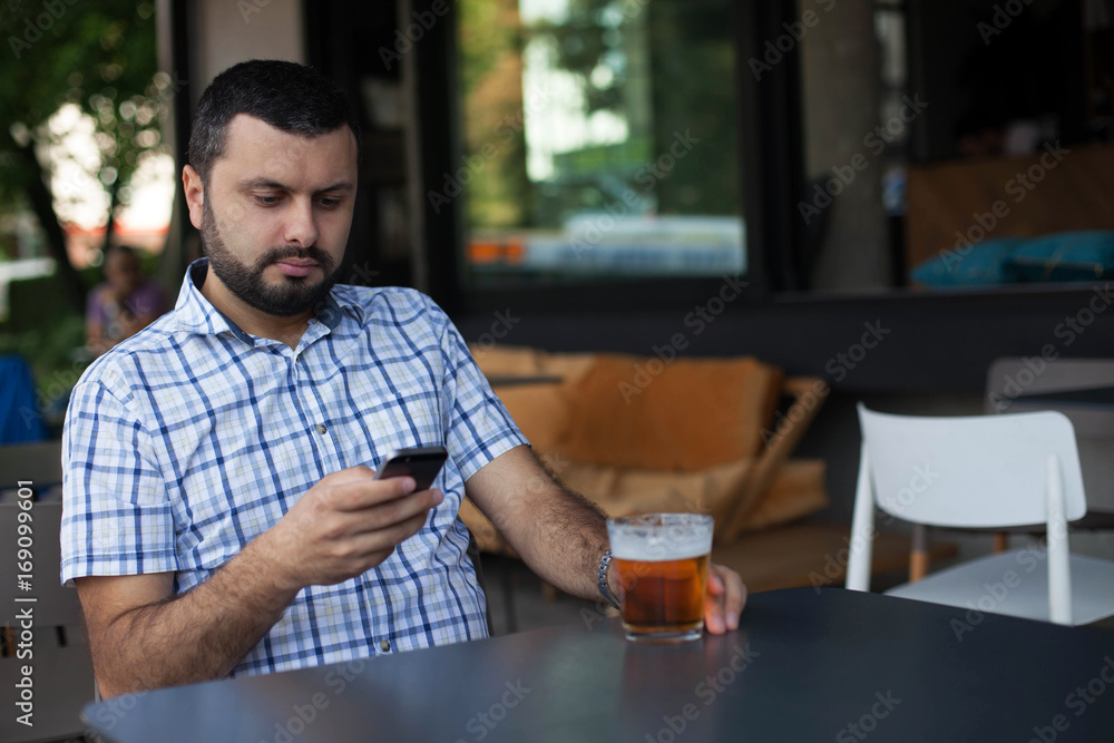 Handsome man using smartphone in bar Handsome man using smartphone in bar