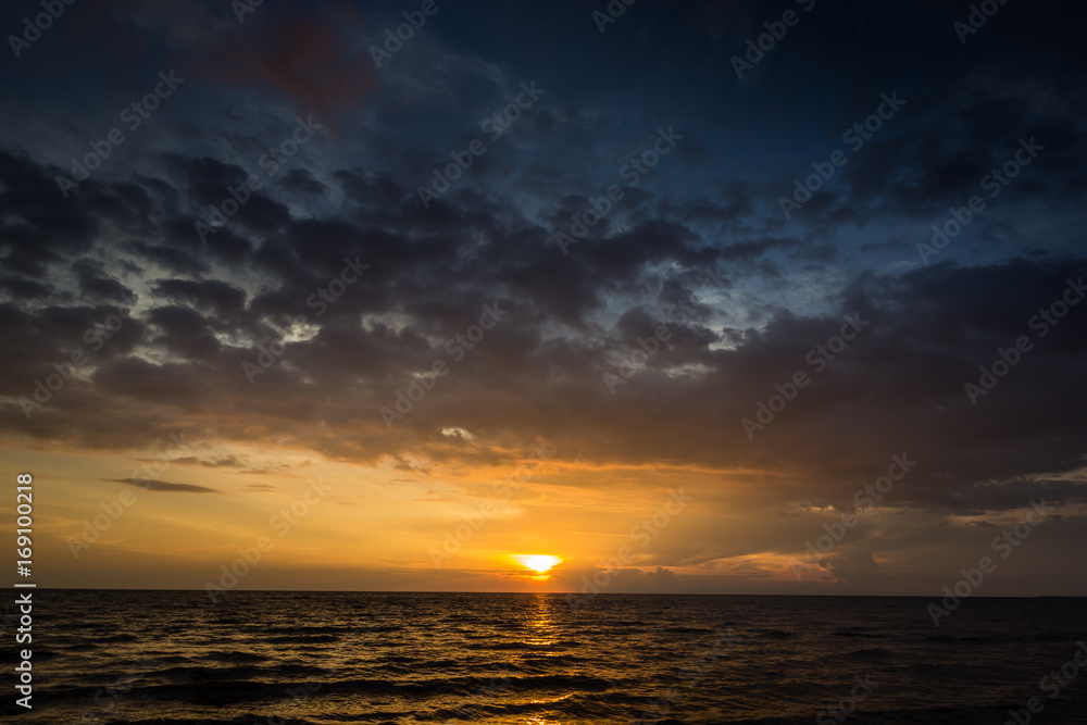 Magic sunset view seascape with beautiful colorful sky, sun and clouds Magic sunset view seascape with beautiful colorful sky, sun and clouds