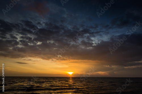 Magic sunset view seascape with beautiful colorful sky, sun and clouds