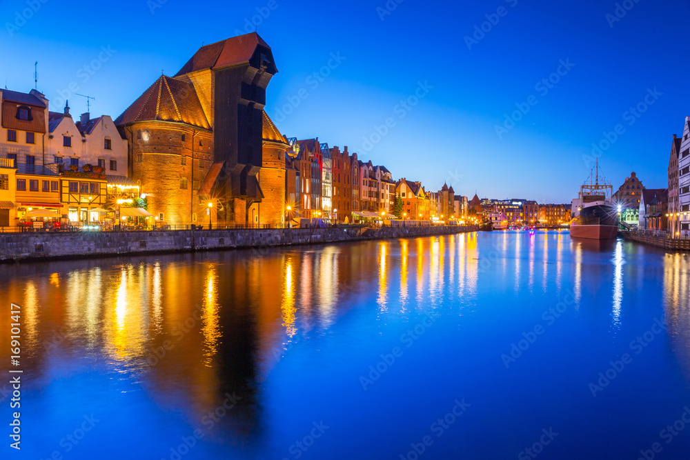Gdansk at night with historic port crane reflected in Motlawa river, Poland