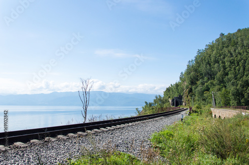 Rails in front of idyllic landscape of Lake Baikal, Siberia, Russia - on a day in summer 2017