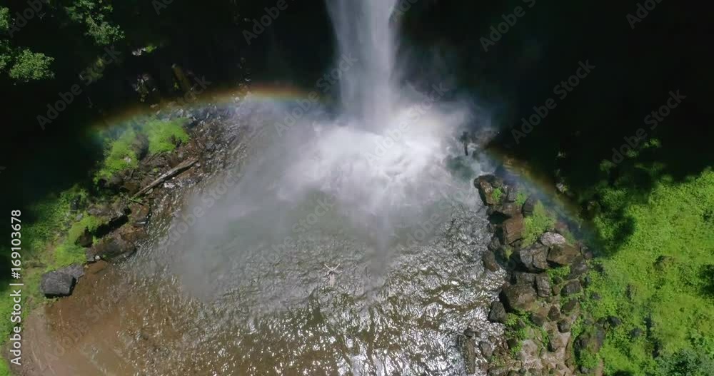 Woman Floating in Waterfall Pool Rising Aerial Shot Woman Floating in Waterfall Pool Rising Aerial Shot