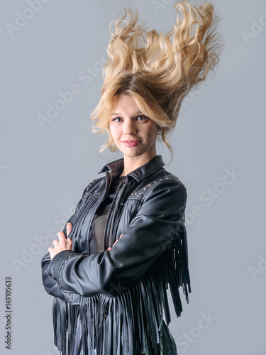 Young woman in a black leather rocker jacket.