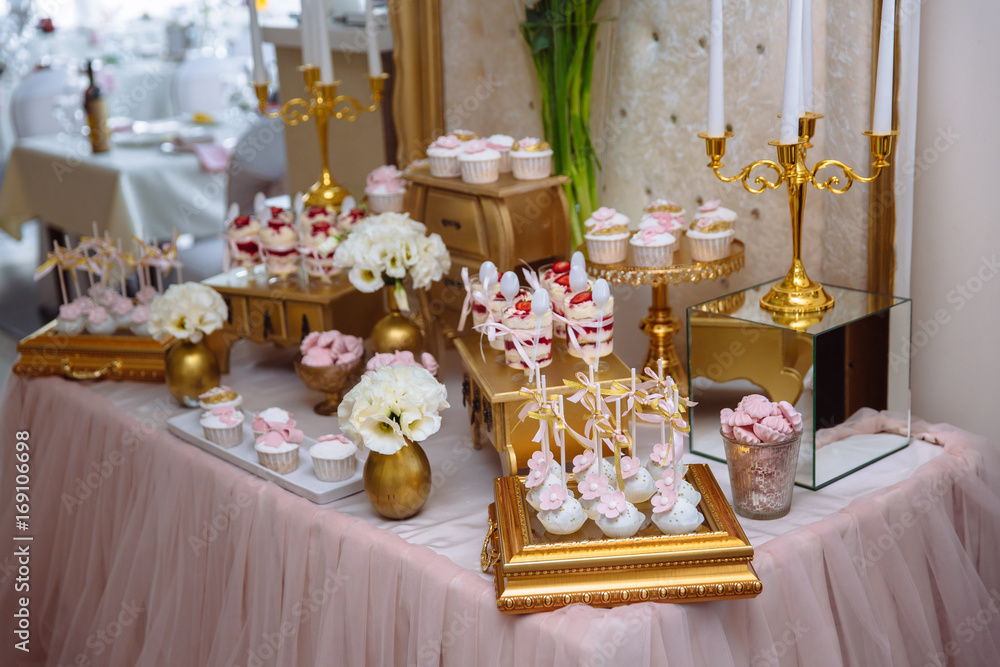 Candy bar. Table with sweets, buffet with cupcakes, candies, dessert.