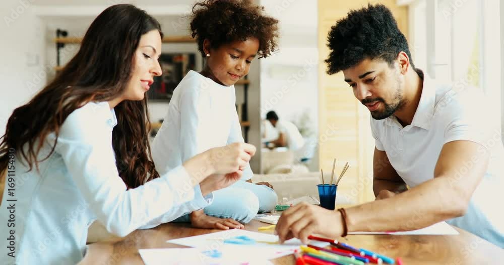 Mother and father drawing together with their child