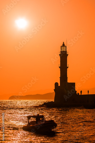 Picture of lighthouse sihoulette in the sunset photo