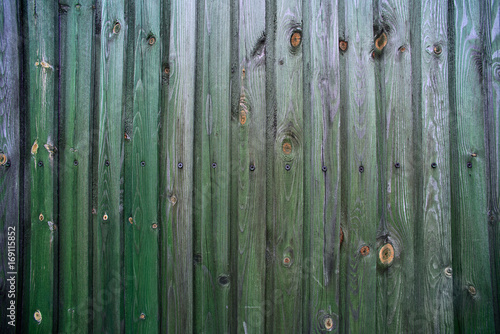 Texture of a green wooden fence of boards