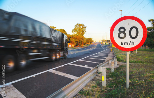Big truck passing at high speed on road exceeding speed limits