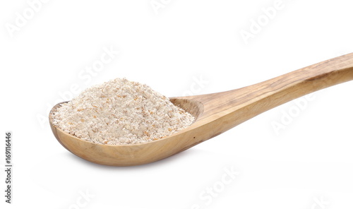 Pile of integral spelt wheat flour in wooden spoon isolated on white background