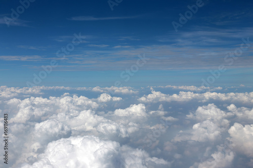 Fototapeta Naklejka Na Ścianę i Meble -  Blue sky and white clouds view from the airplane window