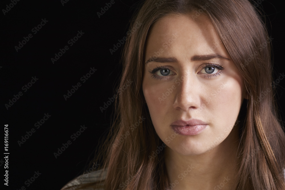 Close Up Head And Shoulders Studio Portrait Of Anxious Woman Close Up Head And Shoulders Studio Portrait Of Anxious Woman
