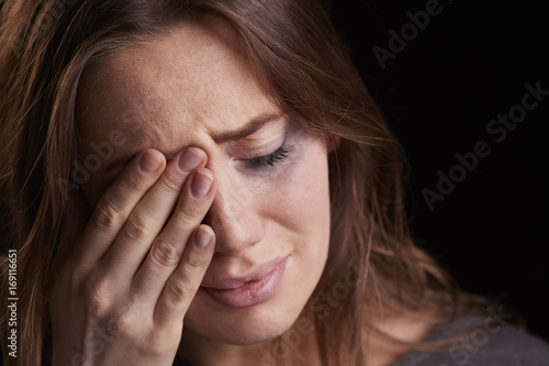 Studio Shot Of Crying Young Woman With Smudged Eye Make Up