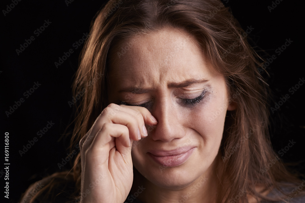 Studio Shot Of Crying Young Woman With Smudged Eye Make Up Studio Shot Of Crying Young Woman With Smudged Eye Make Up