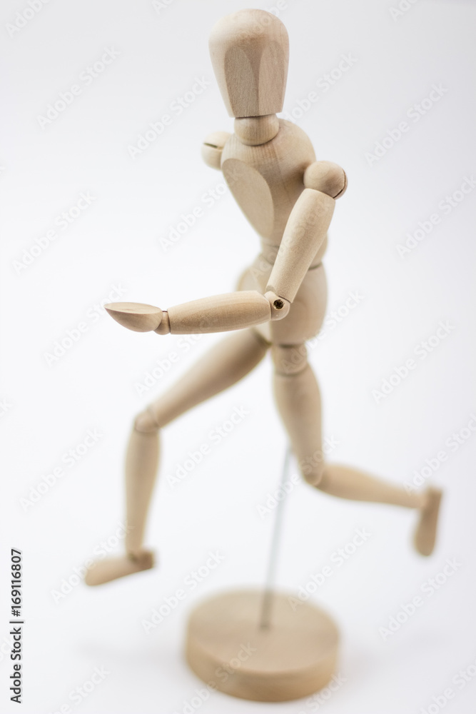 A wooden mannequin running and looking at us. A wooden mannequin running and looking at us.