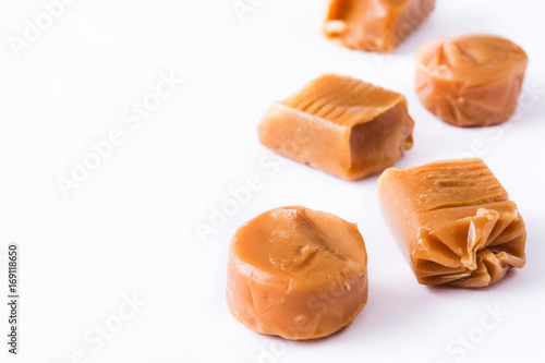 Toffee caramel candies isolated on white background. Copyspace.

