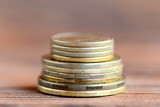 Stack of coins isolated on a wooden background. Finance. Money concept. Closeup