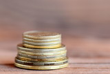 Tower of coins isolated on a wood background. Financial concept. Money. Closeup