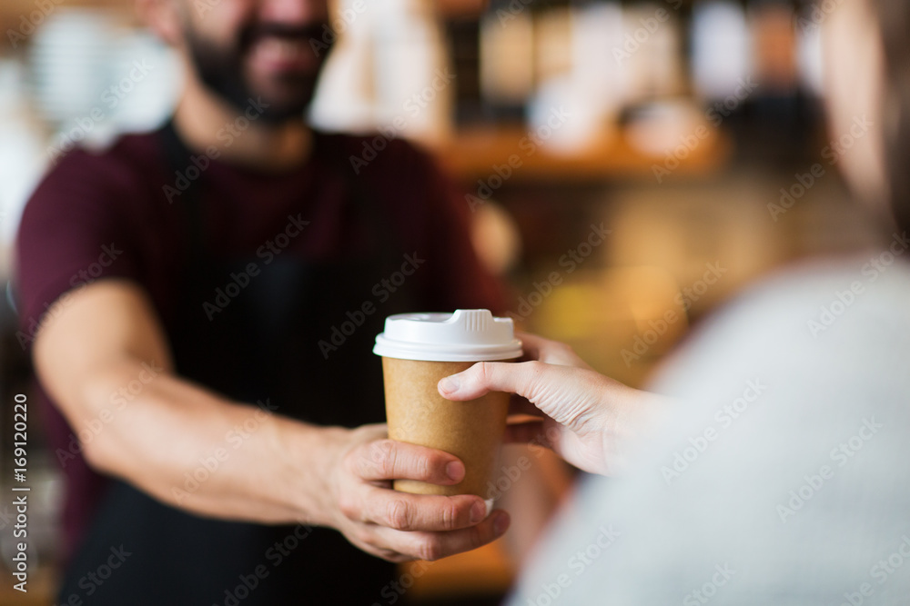man or bartender serving customer at coffee shop man or bartender serving customer at coffee shop