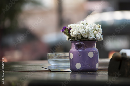 flowers in retro bucket on wooden table