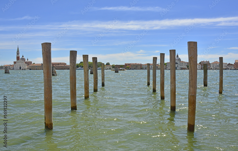 Mooring piles in the Dorsoduro quarter of Venice. Giudecca can be seen across the Giudecca canal. The Chiesa di San Georgio Maggiore can be seen on the left and Le Zittelle on the right.
