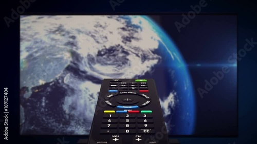 InfraRed Remote controller with luma matte channel. Tv set with Earth planet in background. Computer generated. photo