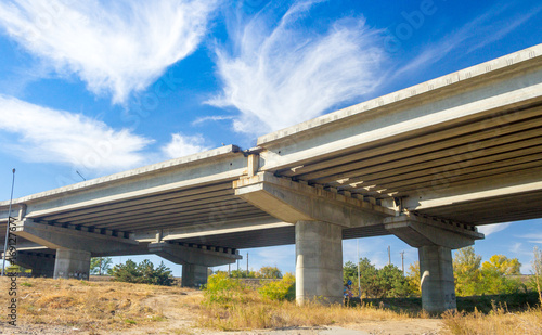 View under the concrete road under construction with bright cirrus clouds in the sky, Zaporozhye, Ukraine